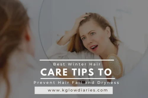 A woman looks into a circular mirror with a concerned expression while holding a hairbrush, featuring a text overlay that reads "Best Winter Hair Care Tips to Prevent Hair Fall and Dryness" and the URL "www.kglowdiaries.com."