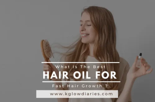 A smiling woman holding a wooden hairbrush and a small glass dropper bottle of oil; text overlay reads "What Is The Best HAIR OIL FOR Fast Hair Growth?"