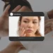 A warm-toned close-up of two people's faces with an inset magnifying glass highlighting the texture of the skin. The text reads "Why Does Skin Look Dull? Main Causes Explained" with a "READ MORE" button and the website www.kglowdiaries.com.