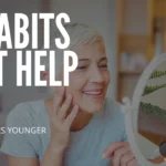 A smiling mature woman with short silver hair looks into a vanity mirror while touching her face; large text overlay reads "12 HABITS THAT HELP YOU LOOK 10 YEARS YOUNGER."