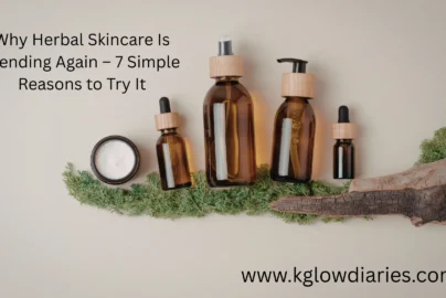 A collection of natural skincare products in amber glass bottles with wooden caps, including a pump bottle, a spray bottle, and two dropper bottles, arranged alongside a jar of white cream and green moss on a neutral background.